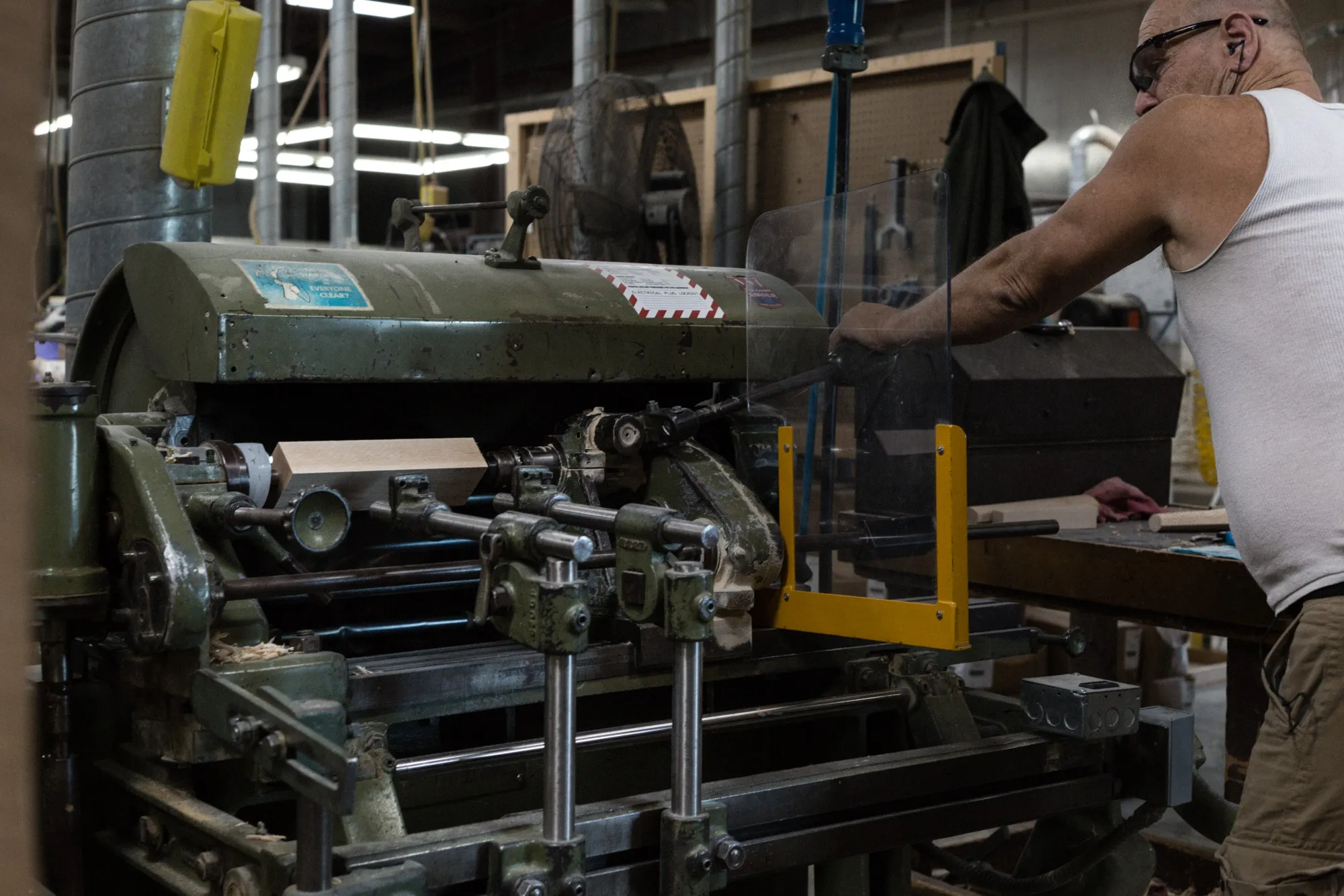 A worker using the manual lathe tin at a manufacturing facility in Random Lake, WI.