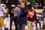 Notre Dame head coach Brian Kelly warms his team up before an NCAA college football game against Virginia on Saturday, Nov. 13, 2021, in Charlottesville, Va. (AP Photo/Mike Caudill)