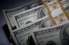 Stacks of U.S. $100 bills are arranged for a photograph in New York, U.S., on Thursday, Feb. 7, 2013. The U.S. dollar advanced in trading today to the highest in almost three weeks against a basket of major currencies.