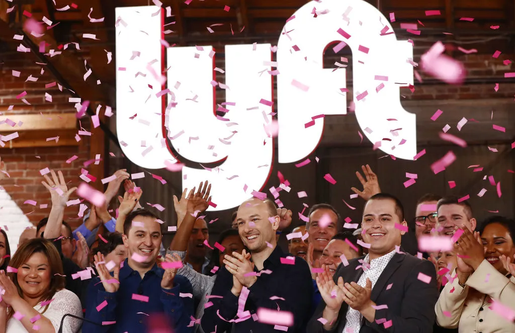Confetti falls as Lyft CEO Logan Green (C) and President John Zimmer (LEFT C) ring the Nasdaq opening bell celebrating the company's initial public offering&nbsp;on March 29, 2019 in Los Angeles, California. (Photo by Mario Tama/Getty Images)