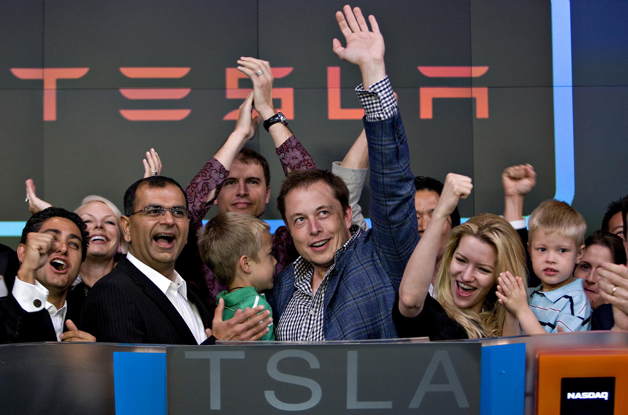 Elon Musk, center, participates in the Nasdaq opening bell ceremony in New York in 2010.