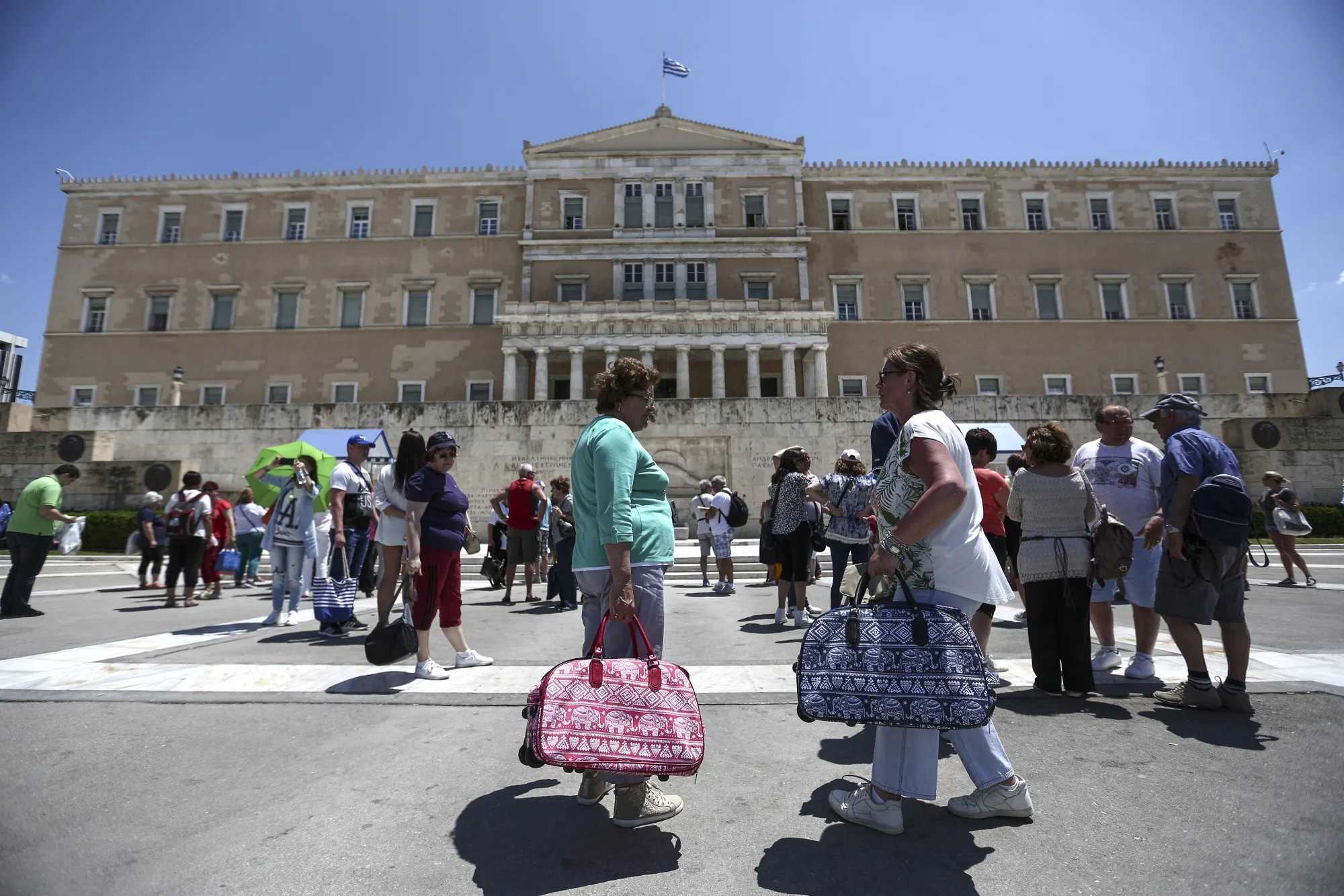 Tourists gather outside the Greek parliament building in Athens, Greece.&nbsp;