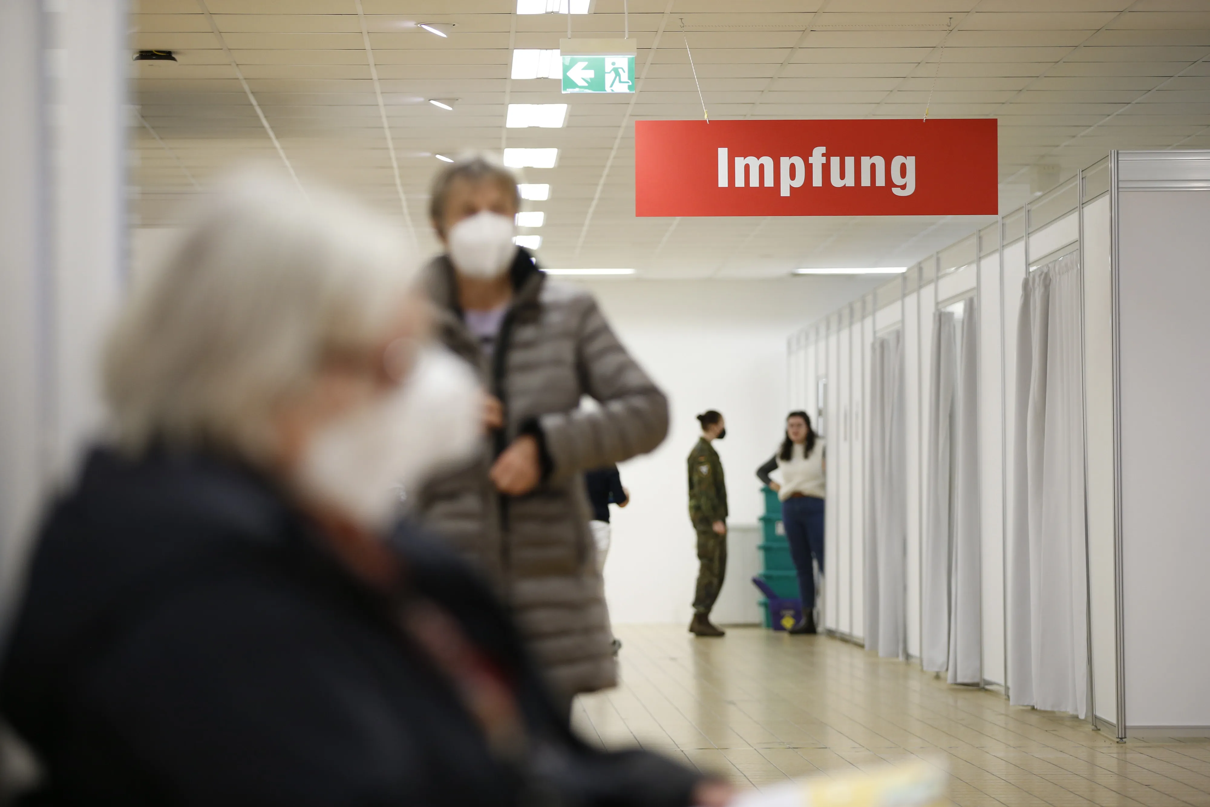 Visitors wait at a Covid-19 vaccine center in Munich.