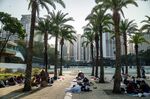 Domestic helpers gather during a rest day at Victoria Park in Hong Kong.
