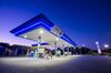 Overhead lighting illuminates pumps on the forecourt of a Sasol Ltd. fuel station in Pretoria.