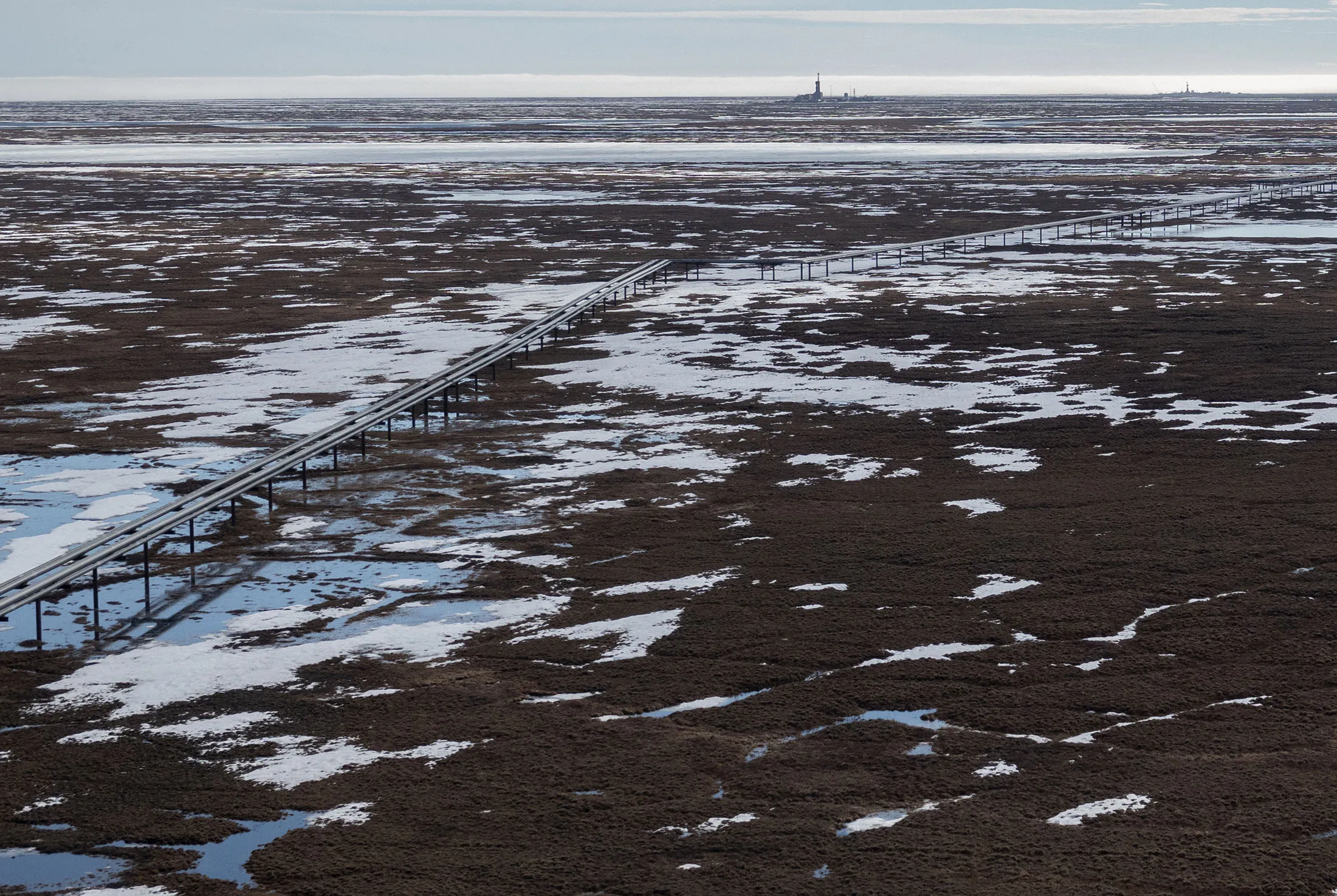 Oil pipelines stretch across the landscape outside Nuiqsut, AK where ConocoPhillips operates the Alpine Field on May 28, 2019.