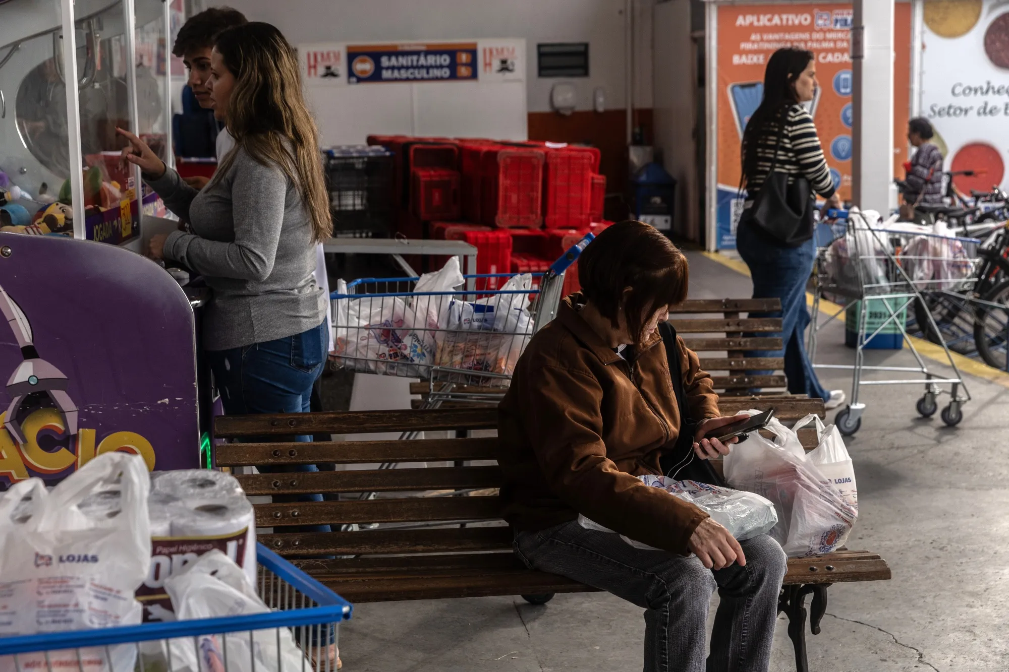 Shoppers carry bags from a grocery store in Sao Jose dos Campos, Sao Paulo state, Brazil.