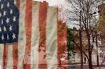 An American flag hangs in a store window in&nbsp;Baltimore, Maryland, on April 25.
