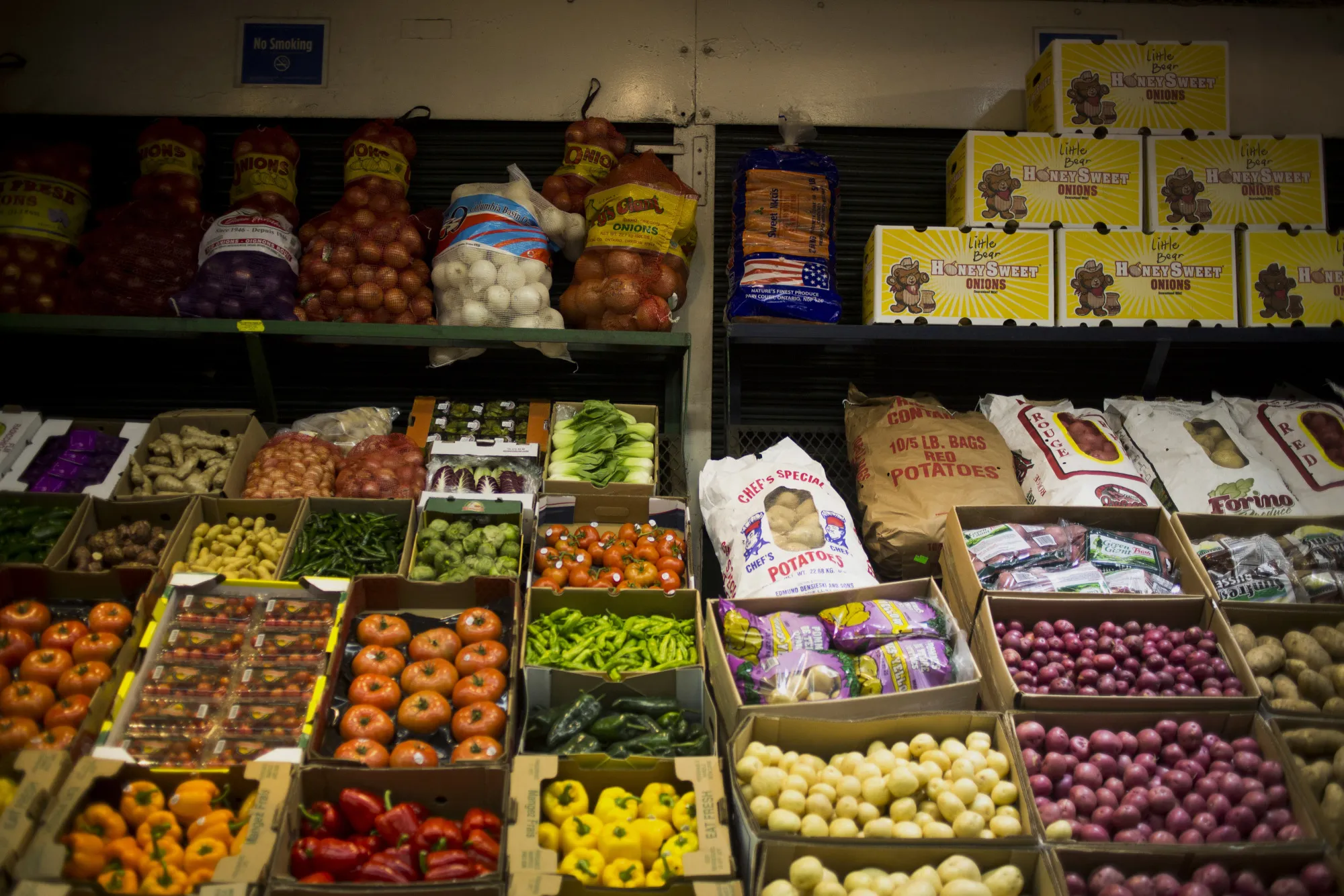 Boxes of fruits and vegetables sit at the Hunts Point Terminal Produce Market in the Bronx borough of New York, U.S., on Monday, Nov. 23, 2015. The Hunts Point Cooperative Market, a wholesale food market, is the largest food distribution center of its kind in the world. 30 million pounds of produce, including sweet potatoes, cranberries, and apples, are delivered for the Thanksgiving holiday to be distributed throughout the Metropolitan Region.