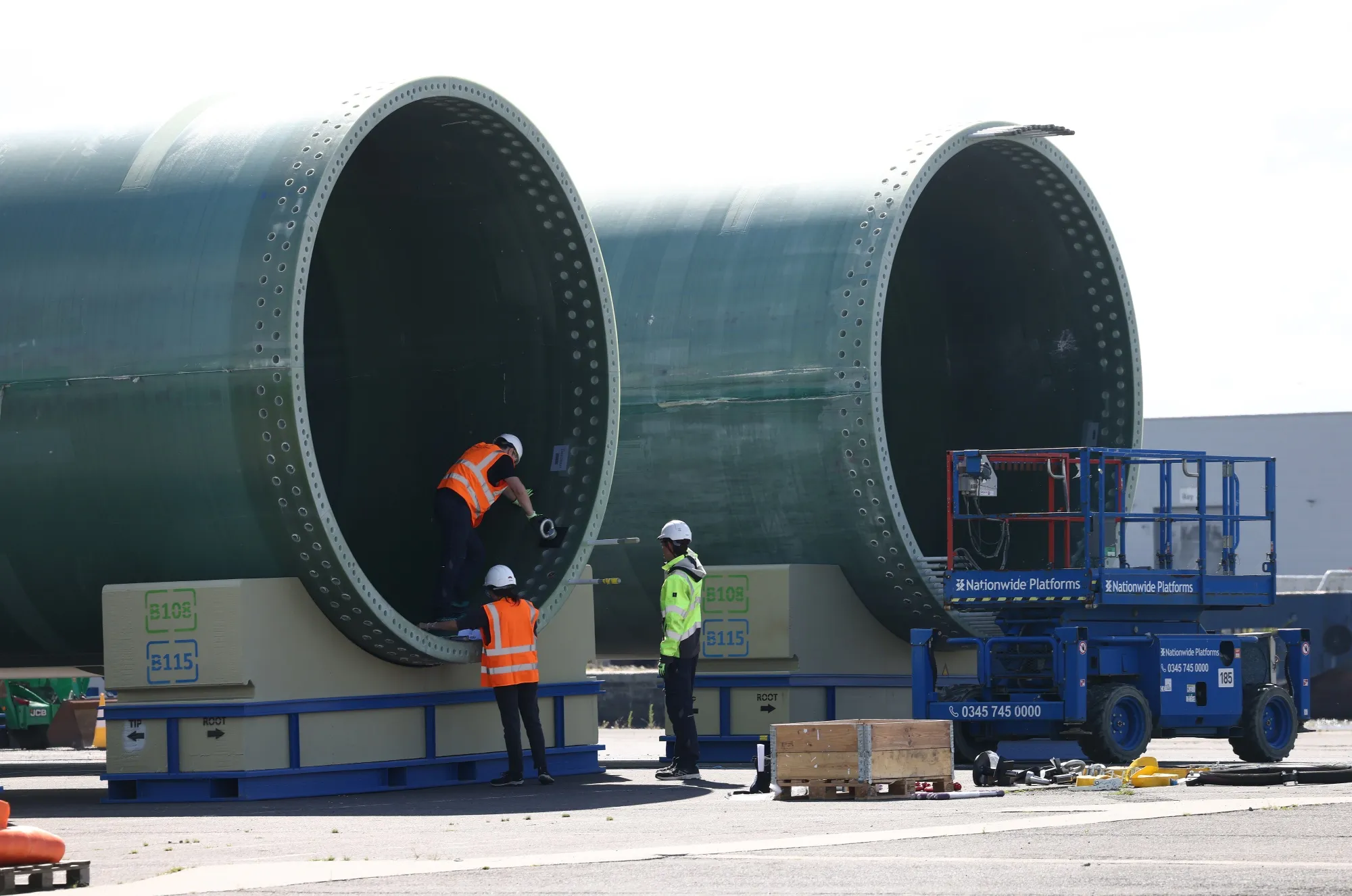 Workers inspect wind turbine blades at the Siemens factory in Hull, UK.