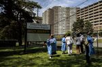 Healthcare workers register people as they wait in line outside a Toronto vaccine clinic on May 19. 