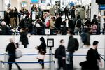 Travelers arrive for flights at Newark Liberty International Airport on November 30, 2021 in Newark, New Jersey.