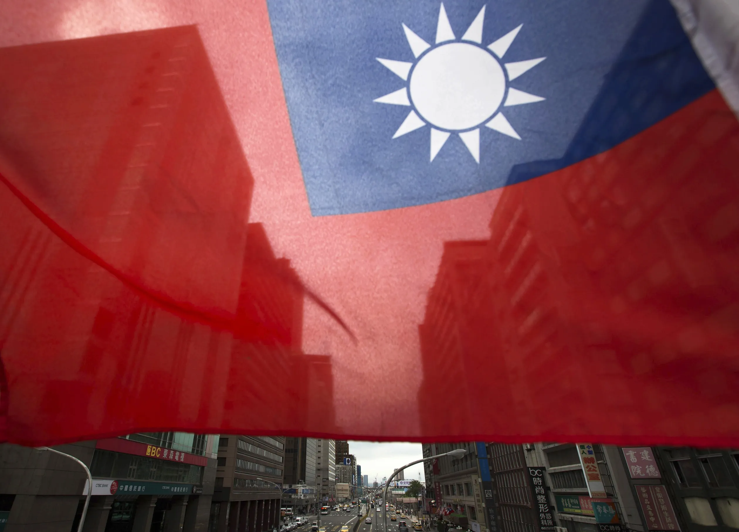A Taiwanese flag flies in front of buildings in Taipei, Taiwan, on Monday, Nov. 9, 2015. In his meeting Saturday with outgoing Taiwanese President Ma Ying-jeou, Chinese President Xi Jinping put the relationship across the Taiwan Strait in clear terms: Stick together, and prosper. Shake things up, and sink the peace.