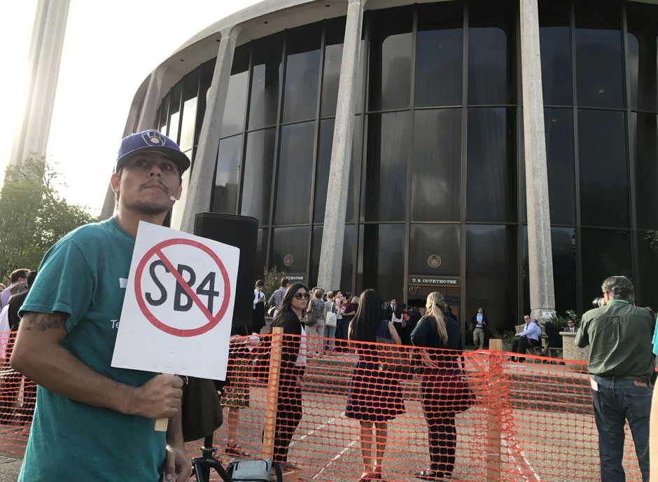 A protester against the Texas state law to punish &quot;sanctuary cities&quot; stands outside the U.S. Federal court in San Antonio, Texas.