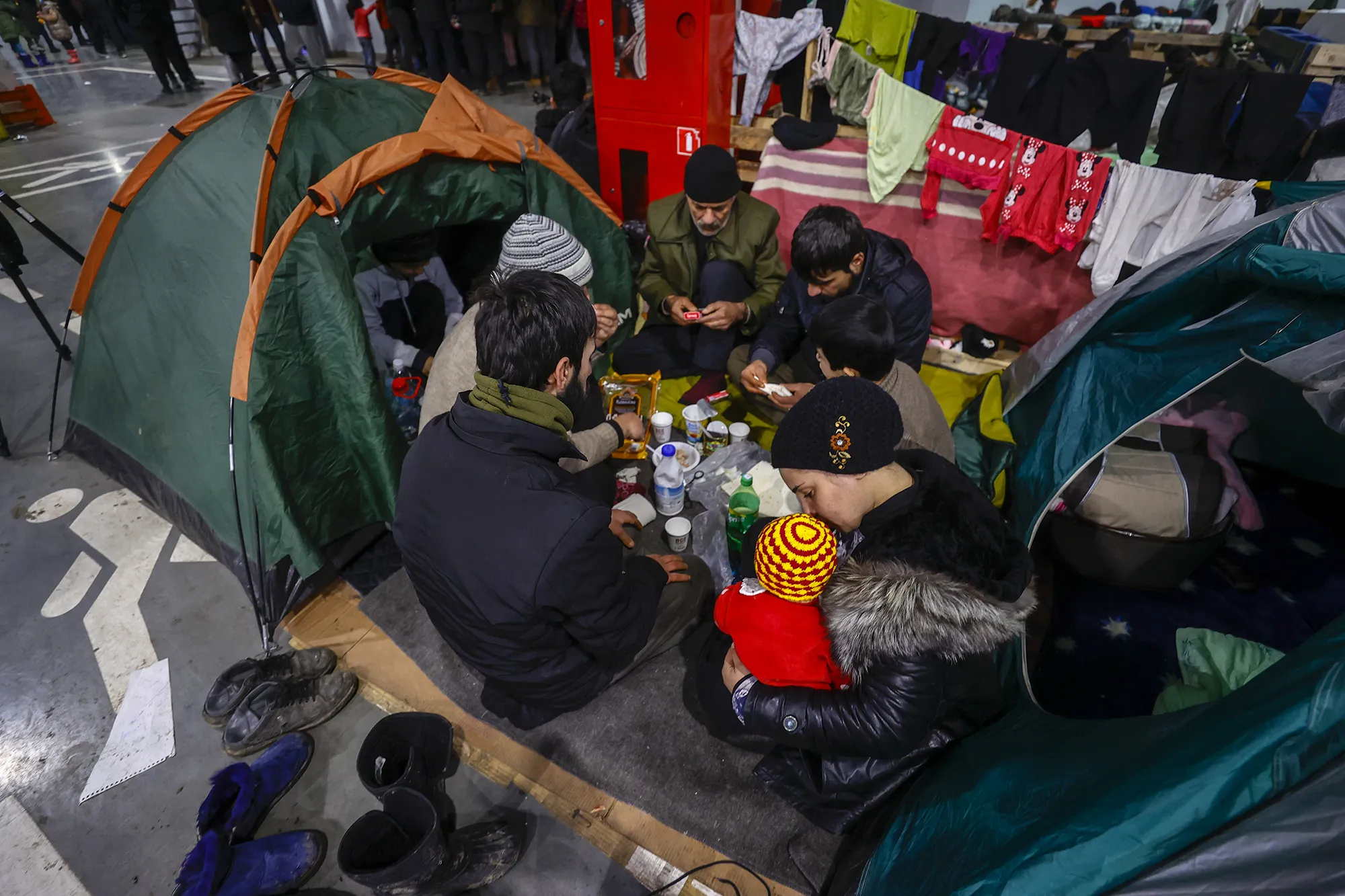 Migrants wait in an area allocated by the Belarusian government at the Belarusian-Polish border in Grodno, Belarus on Dec. 1.&nbsp;
