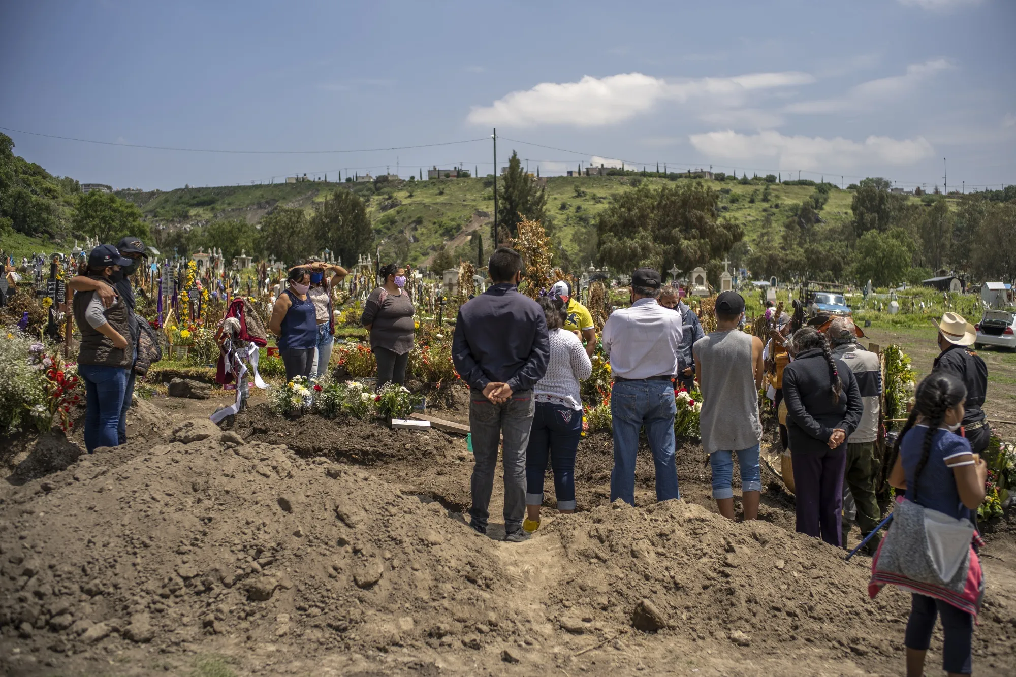 Relatives mourn during the burial of a relative who died from the coronavirus at San Miguel Xico cemetery in Mexico City, Mexico, on&nbsp;Aug.&nbsp;5.