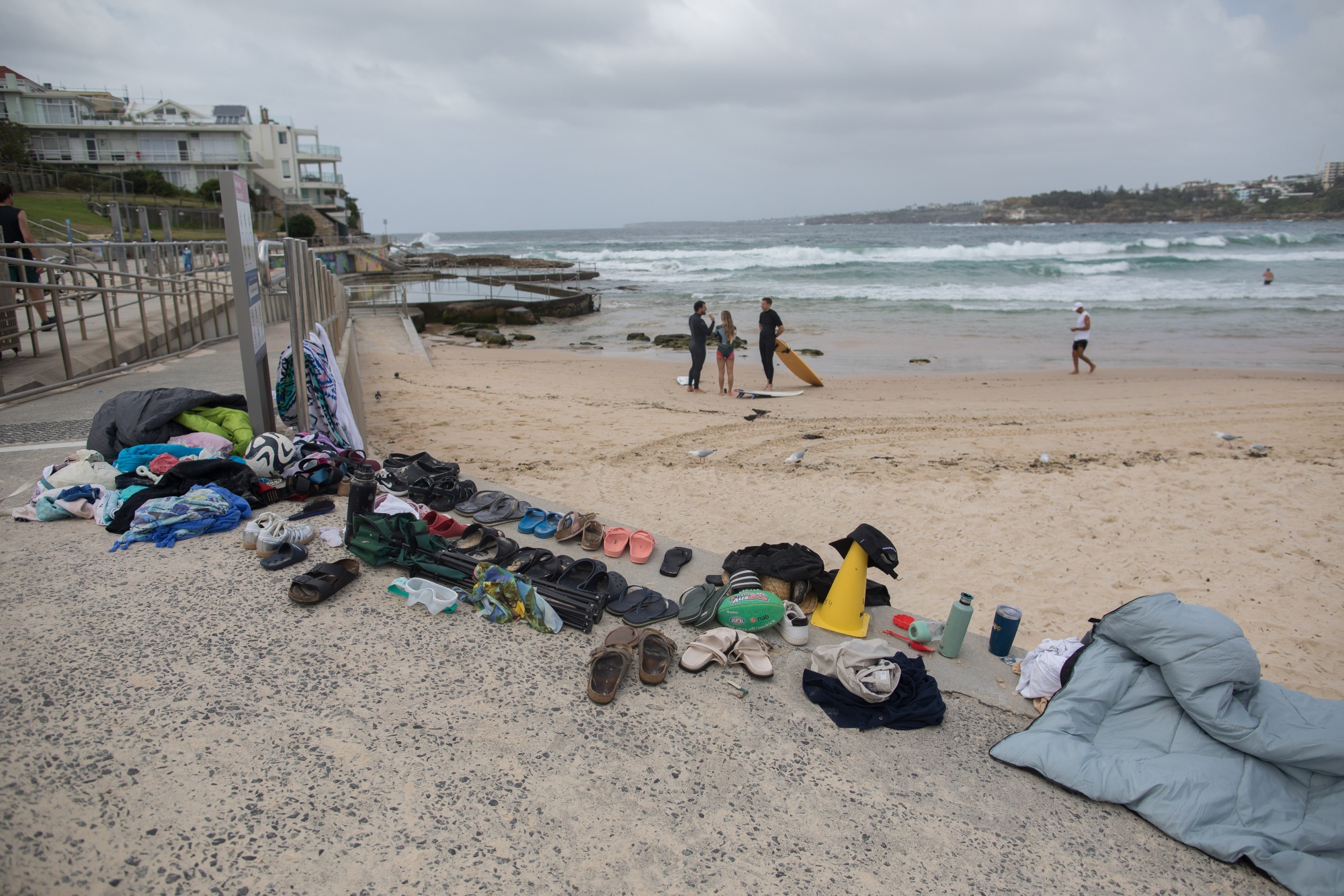 Shoes and other personal belongings abandoned during a mass shooting gathered to a side at Bondi Beach in Sydney, Australia, on Monday, Dec. 15, 2025. Sixteen people have been killed in Australia's worst terrorist attack after gunmen opened fire on Jewish people who had gathered to celebrate the first day of Hanukkah at Sydney's iconic Bondi Beach on Sunday evening. Photographer: Brent Lewin/Bloomberg