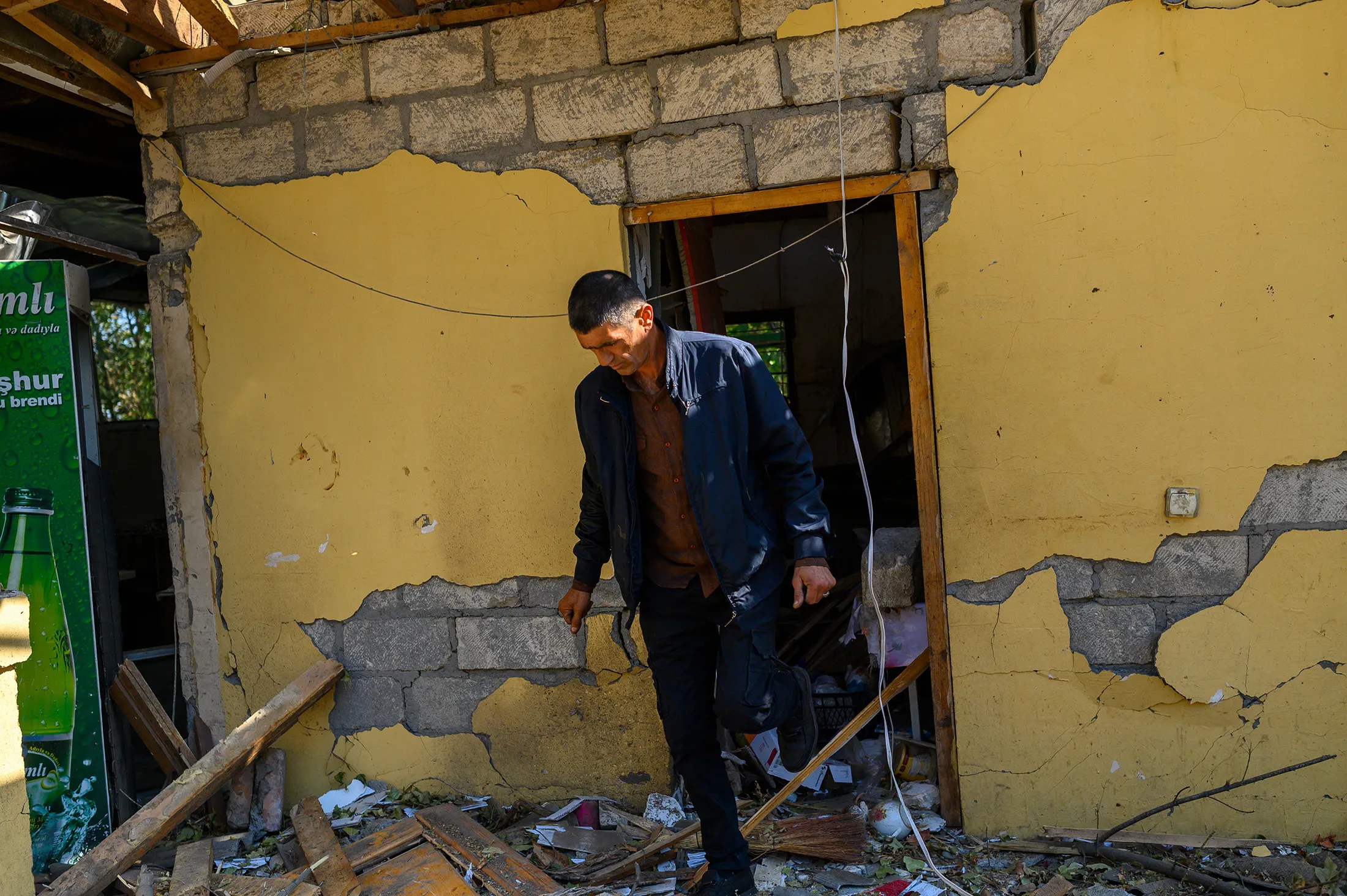 A resident walks in front of a damaged building in Barda, Azerbaijan, near the disputed Nagorno-Karabakh province's capital Stepanakert, on Oct. 9.