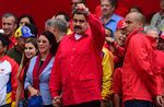 Venezuelan President Nicolas Maduro, center, who is resisting efforts by the opposition to remove him from power in a volatile political crisis, gestures at supporters in Caracas on October 25, 2016.
