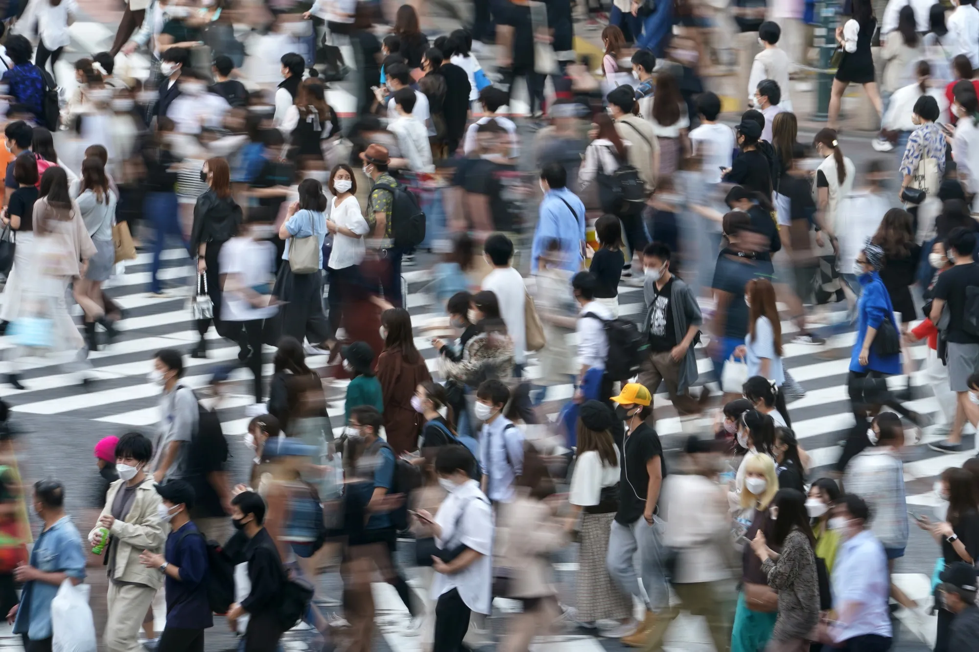 Pedestrians cross an intersection in the Shibuya district of Tokyo.