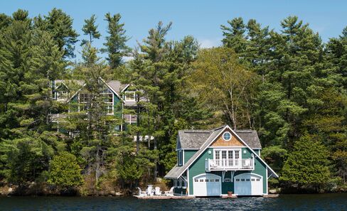A large cottage and its boat house on the shores of Lake Rosseau. Photographer: James MacDonald/Bloomberg