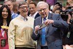 Warren Buffett, Berkshire Hathaway Inc. chairman and chief executive officer, right, talks with Bill Gates, billionaire and co-chair of the Bill and Melinda Gates Foundation, as they tour the exhibition floor during the Berkshire Hathaway Inc. annual shareholders meeting in Omaha, Nebraska, U.S., on Saturday, May 2, 2015.
