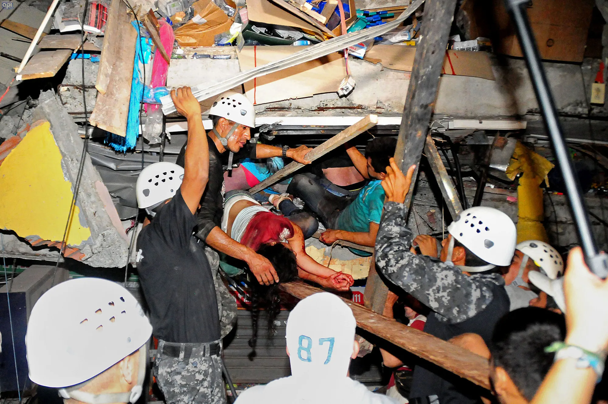 Rescue workers work to pull out survivors trapped in a collapsed building after a huge earthquake struck, in the city of Manta early on April 17, 2016. Photographer: Ariel Ochoa/AFP/Getty Images

