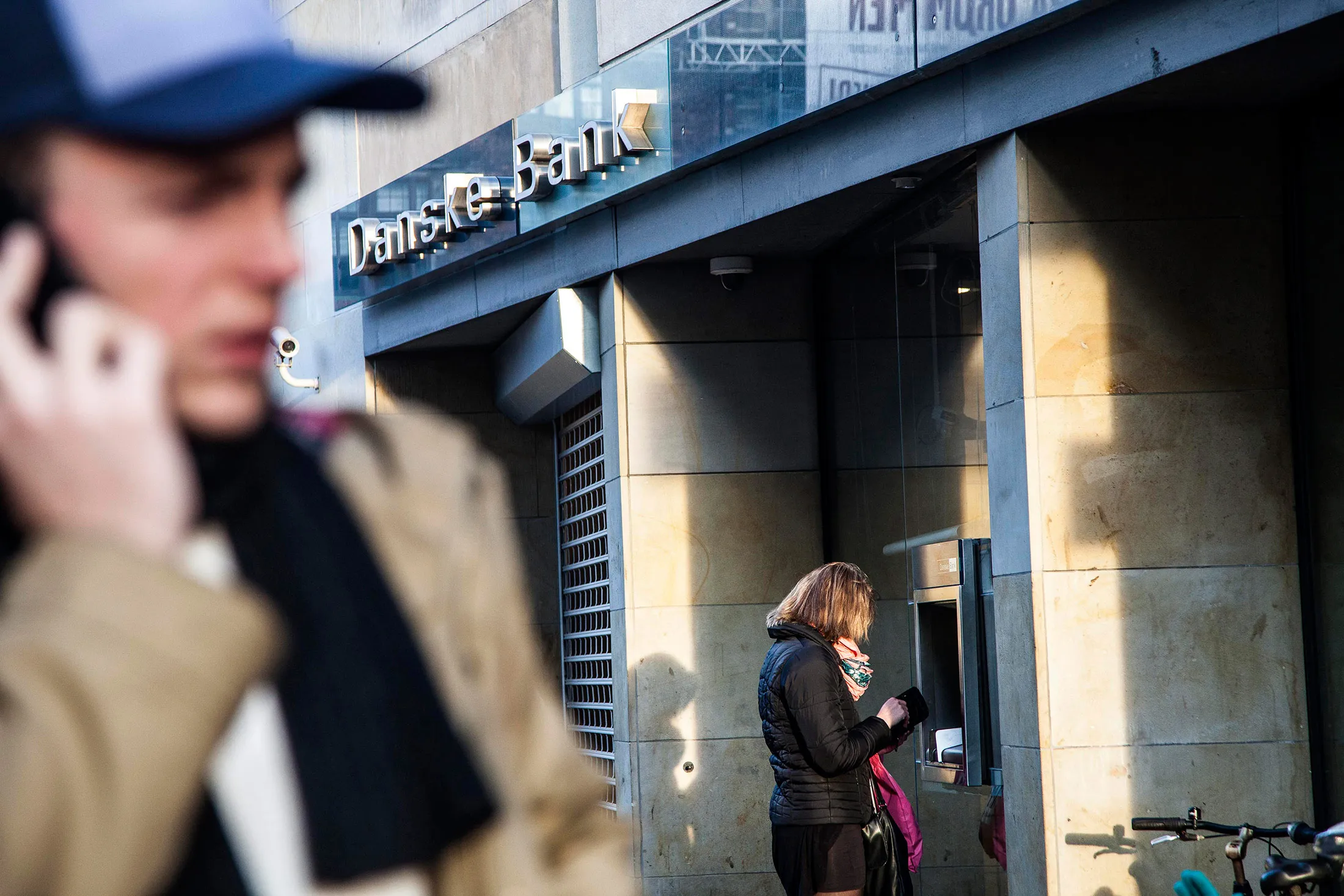A customer uses an automated teller machine (ATM) outside a Danske Bank A/S bank branch in Copenhagen.
