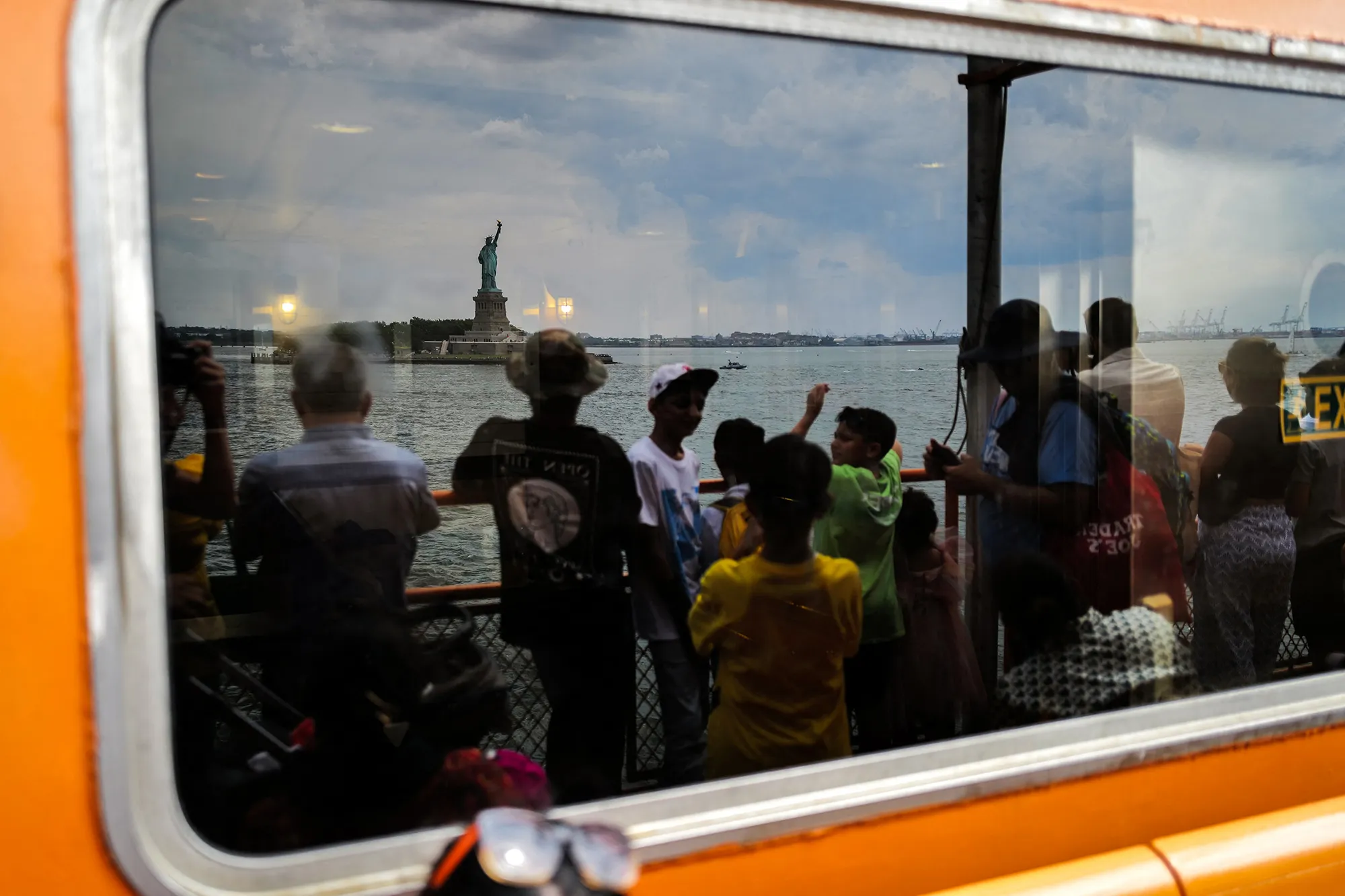 A reflection of the Statue of Liberty&nbsp;as passengers ride the Staten Island ferry&nbsp;in New York.
