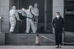 Medical staff carry a patient into the Jinyintan hospital, where patients infected by a mysterious SARS-like virus are being treated, in Wuhan, on Jan. 18.