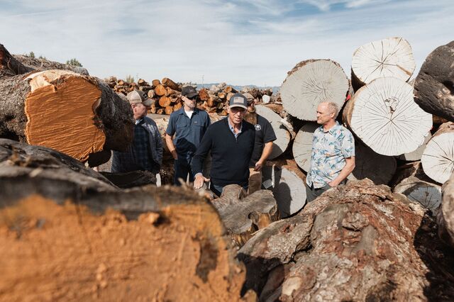 Bob Taylor (center) tours the log yards of Anaheim, California-based West Coast Arborists, a contractor that plants, trims and removes trees for hundreds of southwest U.S. cities. West Coast supplies the wood Taylor is using on its ‘Urban Ash’ guitar line.