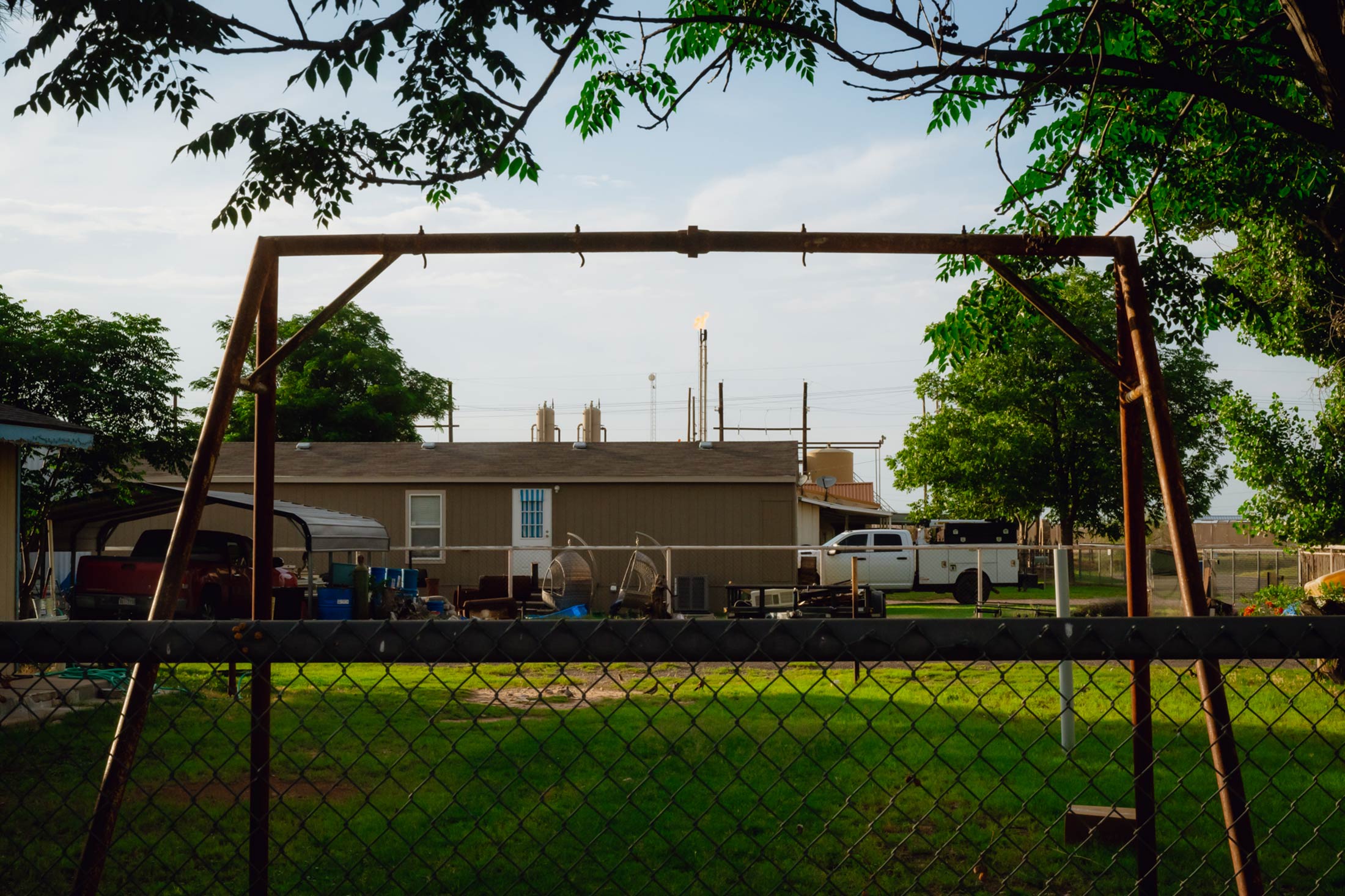 A gas flare burns behind homes in Texas.