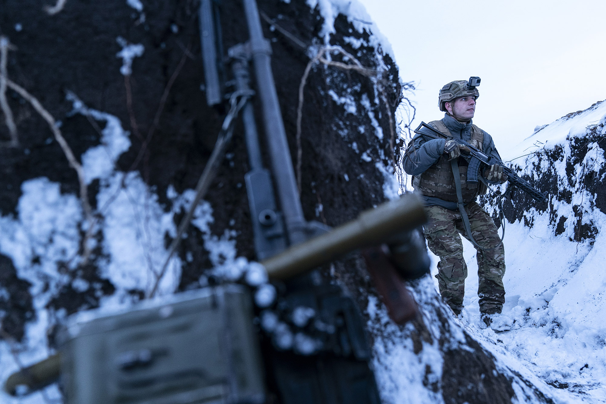 A Ukrainian serviceman guards his position near the line of contact near Vodiane.&nbsp;
