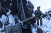 A Ukrainian serviceman guards his position near the line of contact near Vodiane. 