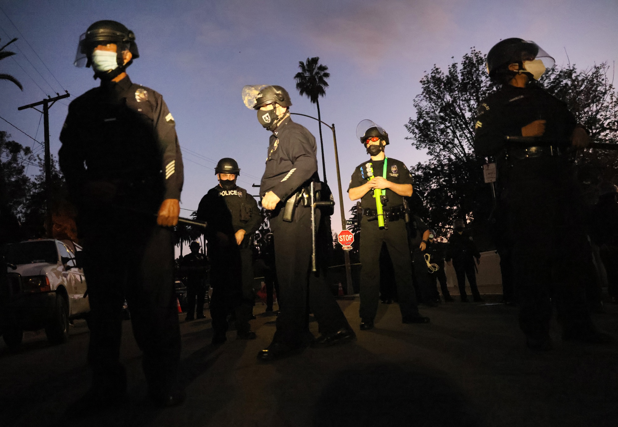 LAPD officers block the street near Echo Park Lake as protesters demonstrate nearby against the removal of a homeless encampment in March.&nbsp;