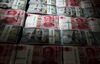 Genuine bundles of Chinese one-hundred yuan banknotes and U.S. one-hundred dollar banknotes are arranged for a photograph at the Counterfeit Notes Response Center of KEB Hana Bank in Seoul, South Korea, on Friday, July 13, 2017. Yuan is set to slide for fifth week, longest losing streak since July 2016, as escalating U.S.-China trade tensions weigh on sentiment.