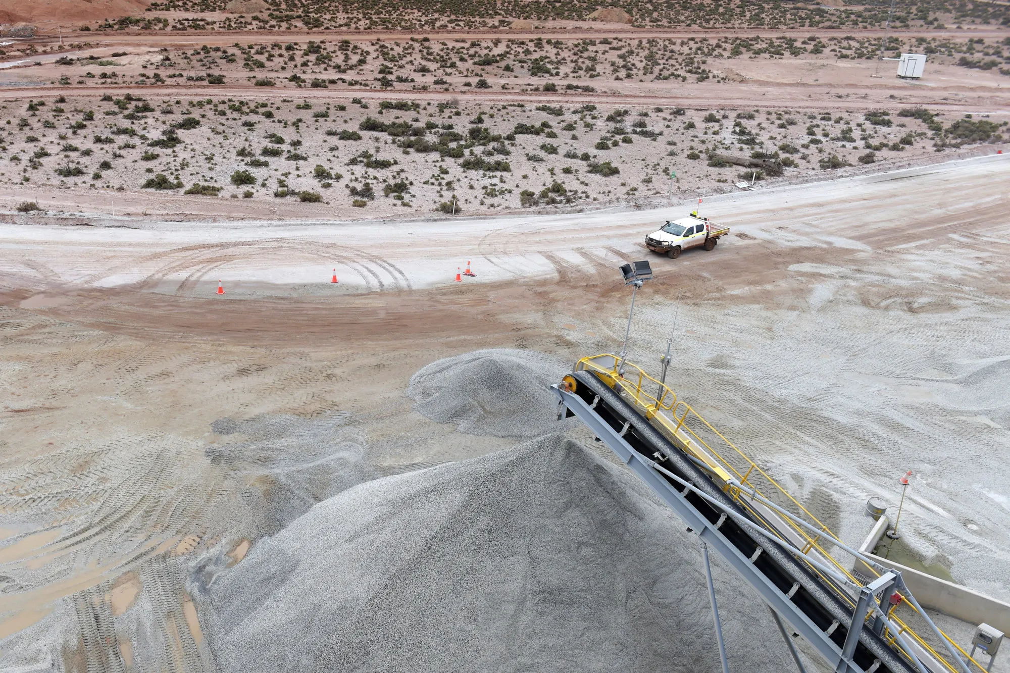 Ore falls from a conveyor onto a stockpile at a lithium mine&nbsp;outside of Widgiemooltha, Australia.