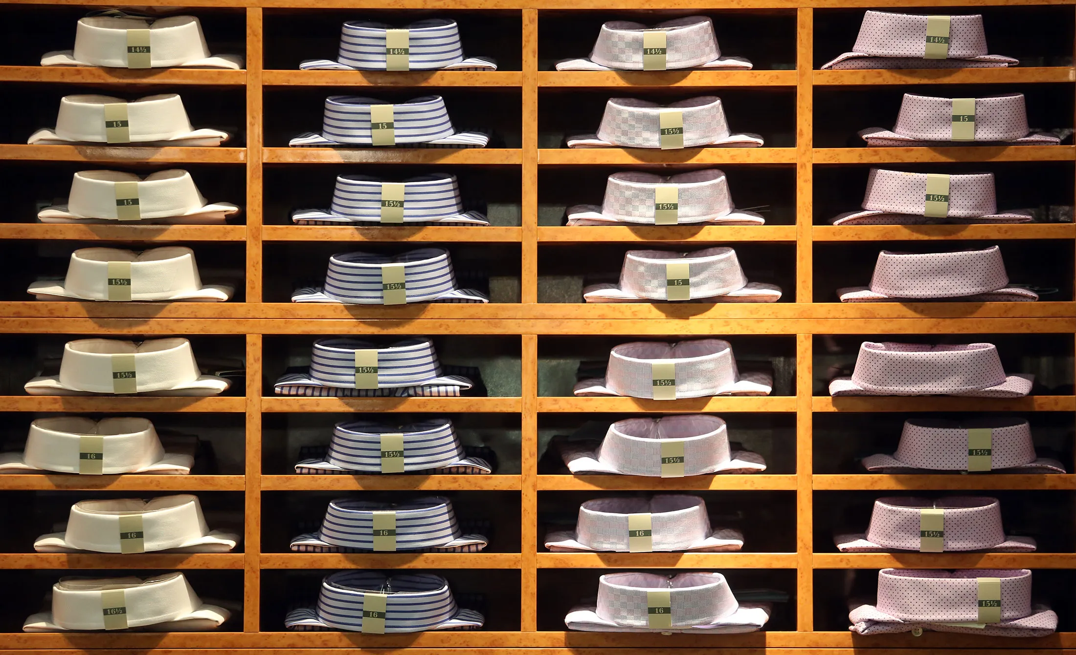 Mens shirts sit in a wooden display cabinet inside a branch of Marks &amp; Spencer Group Plc (M&amp;S) in London.
