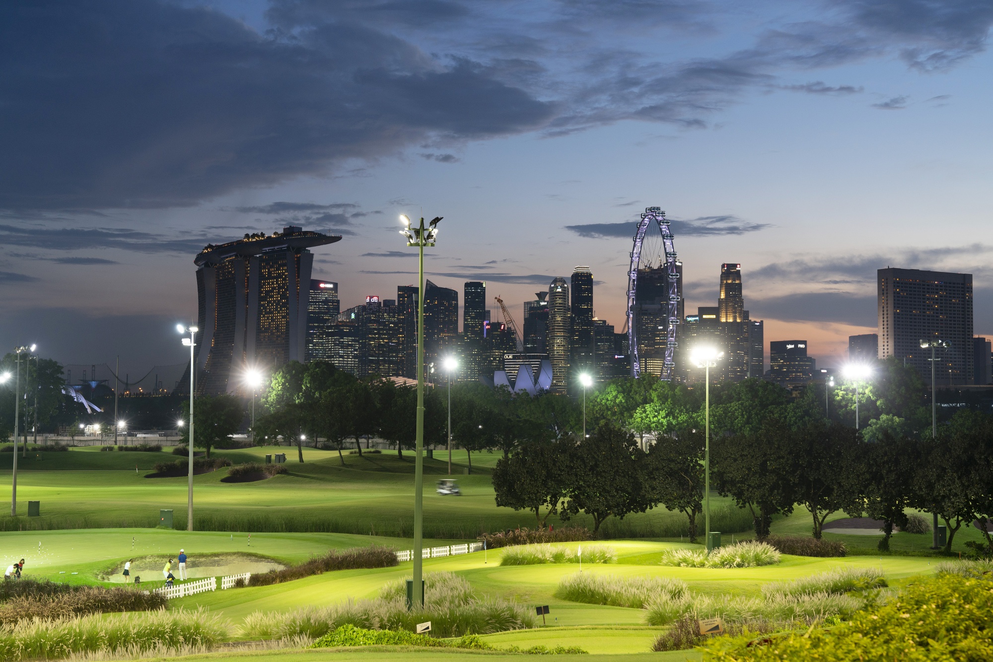 Golfers play evening rounds at the Marina Bay Golf Course in Singapore on April 6.