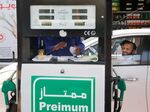 A worker writes a receipt at a gas station in Jiddah, Saudi Arabia.