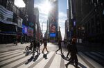 Pedestrians walk through the Times Square area of New York, U.S., on Friday, Jan. 21, 2022. 