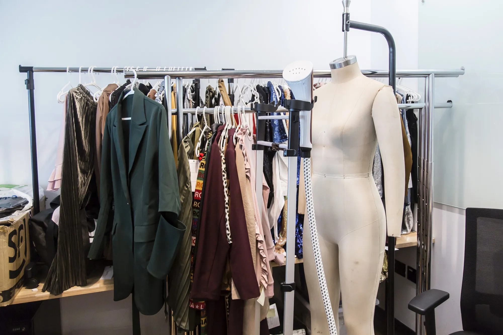 Clothing items hang on racks next to a mannequin at the Zilingo Pte office in Singapore.