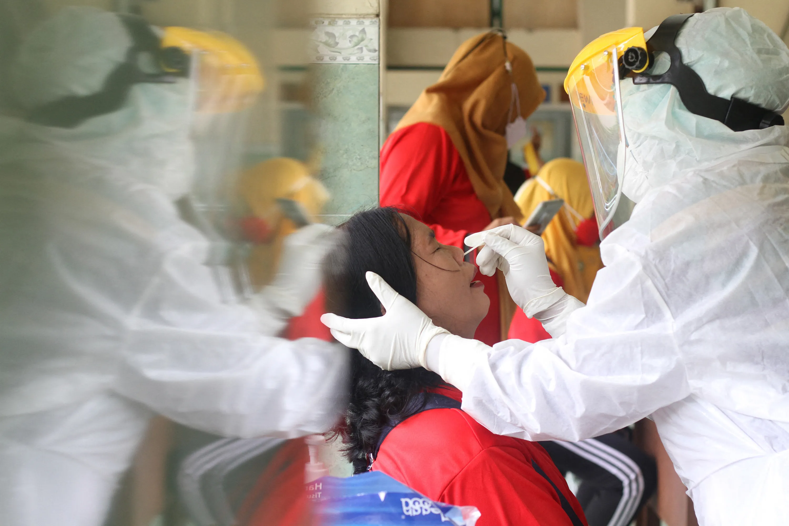 Health workers perform PCR tests in Solo, Java, Indonesia.
