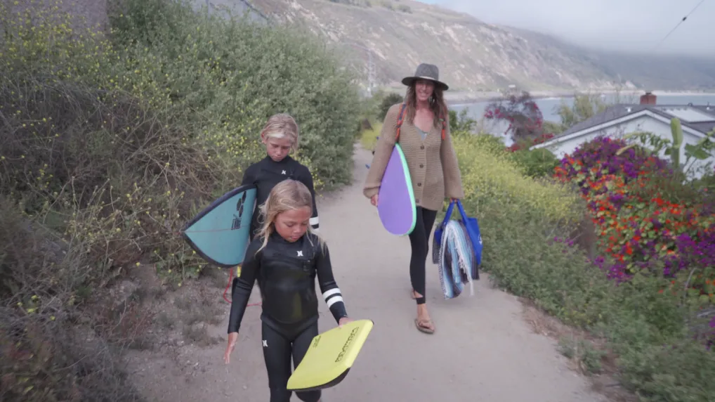 Surf school co-owner Jenny Keet, pictured with sons Maddox (top) and Jack, has had to adapt her business during the pandemic.
