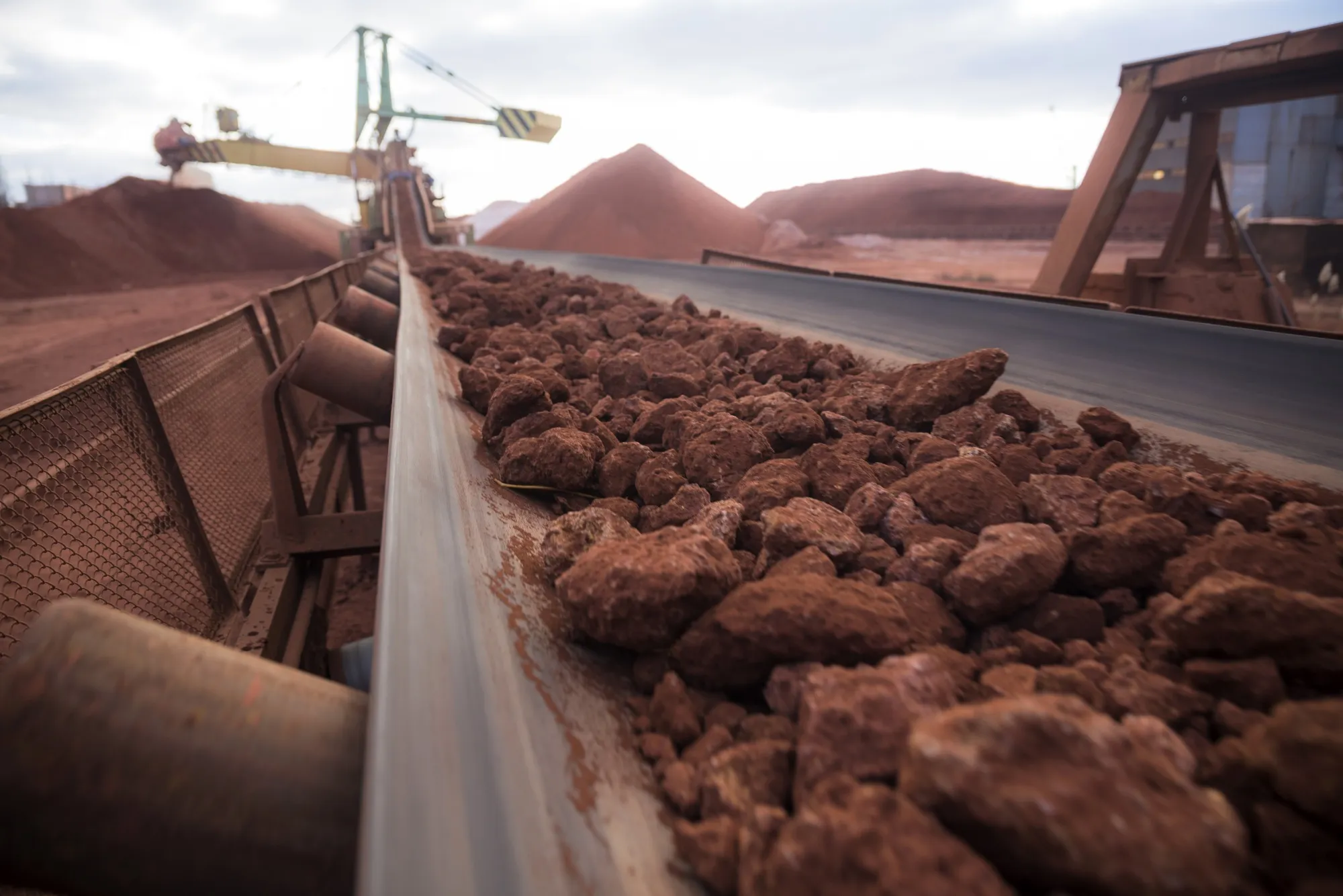 Bauxite rock passes along a conveyor belt to the reclaimer machine at an aluminium oxide factory in Nikolaev, Ukraine.