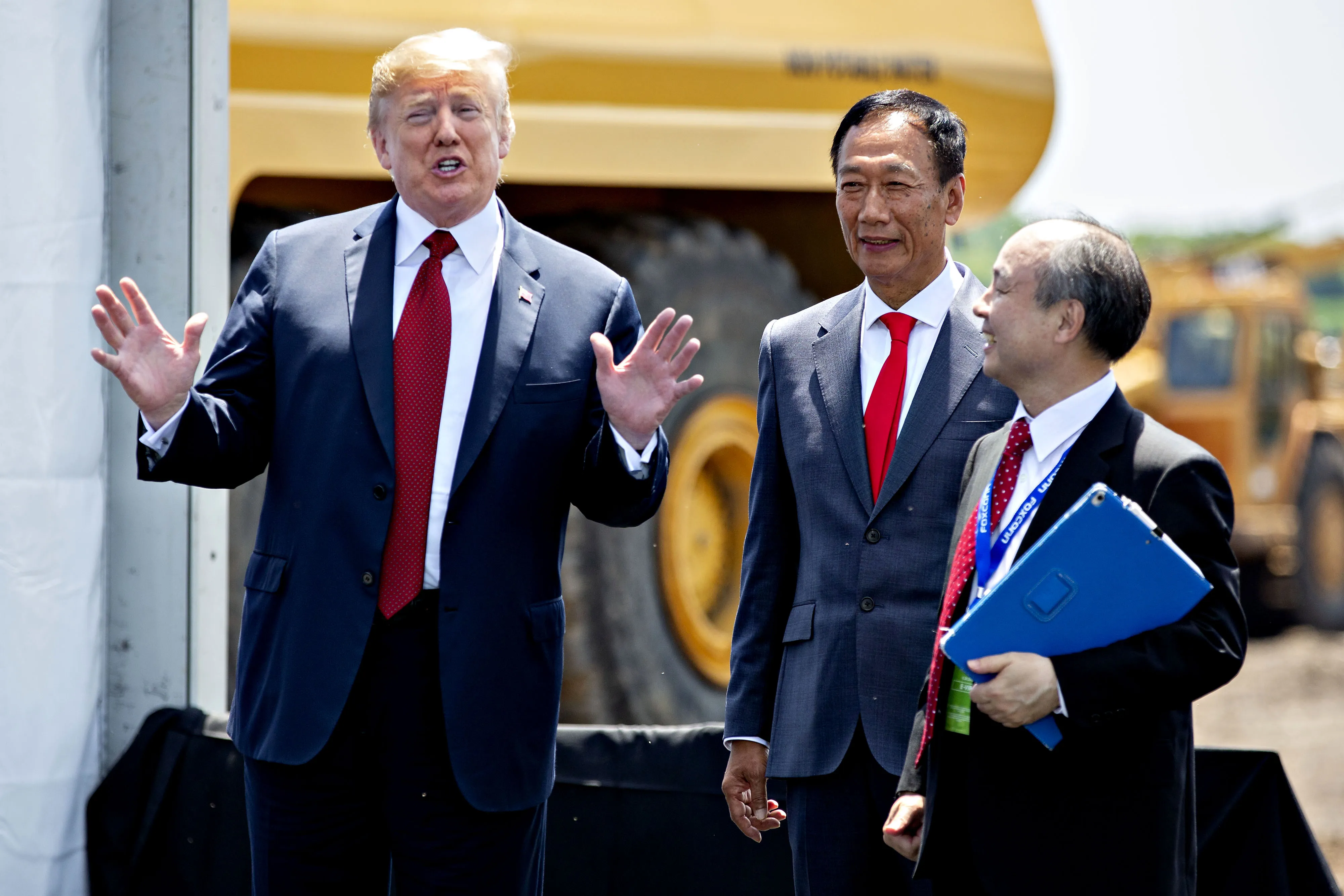 Donald Trump stands with Foxconn founder Terry Gou and SoftBank founder Masayoshi Son in 2018.