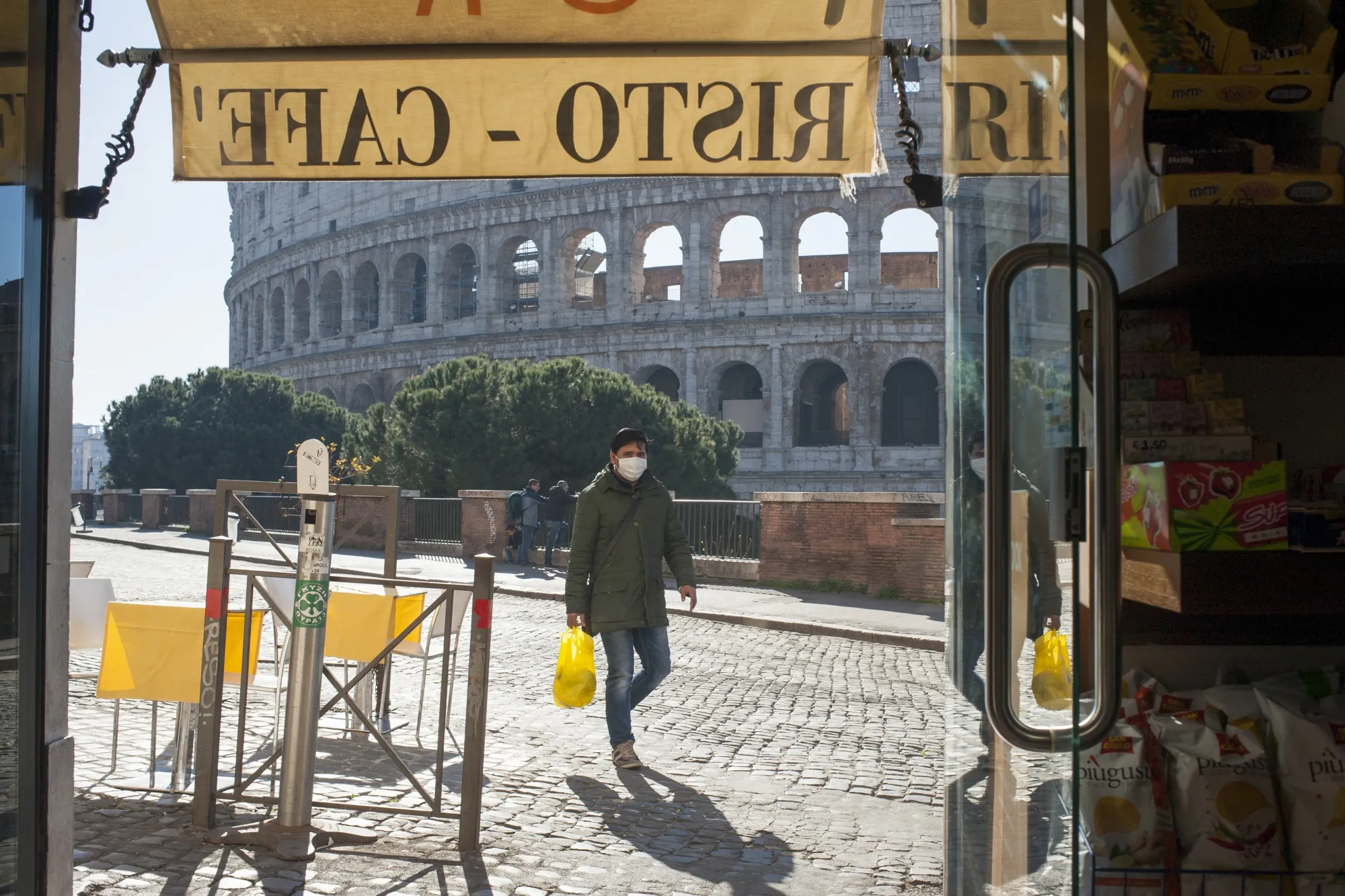 A pedestrian walks near the Colosseum in Rome, on March 11.