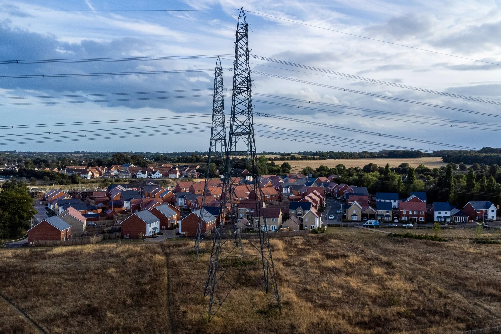 Electricity pylons next to residential housing in the UK.