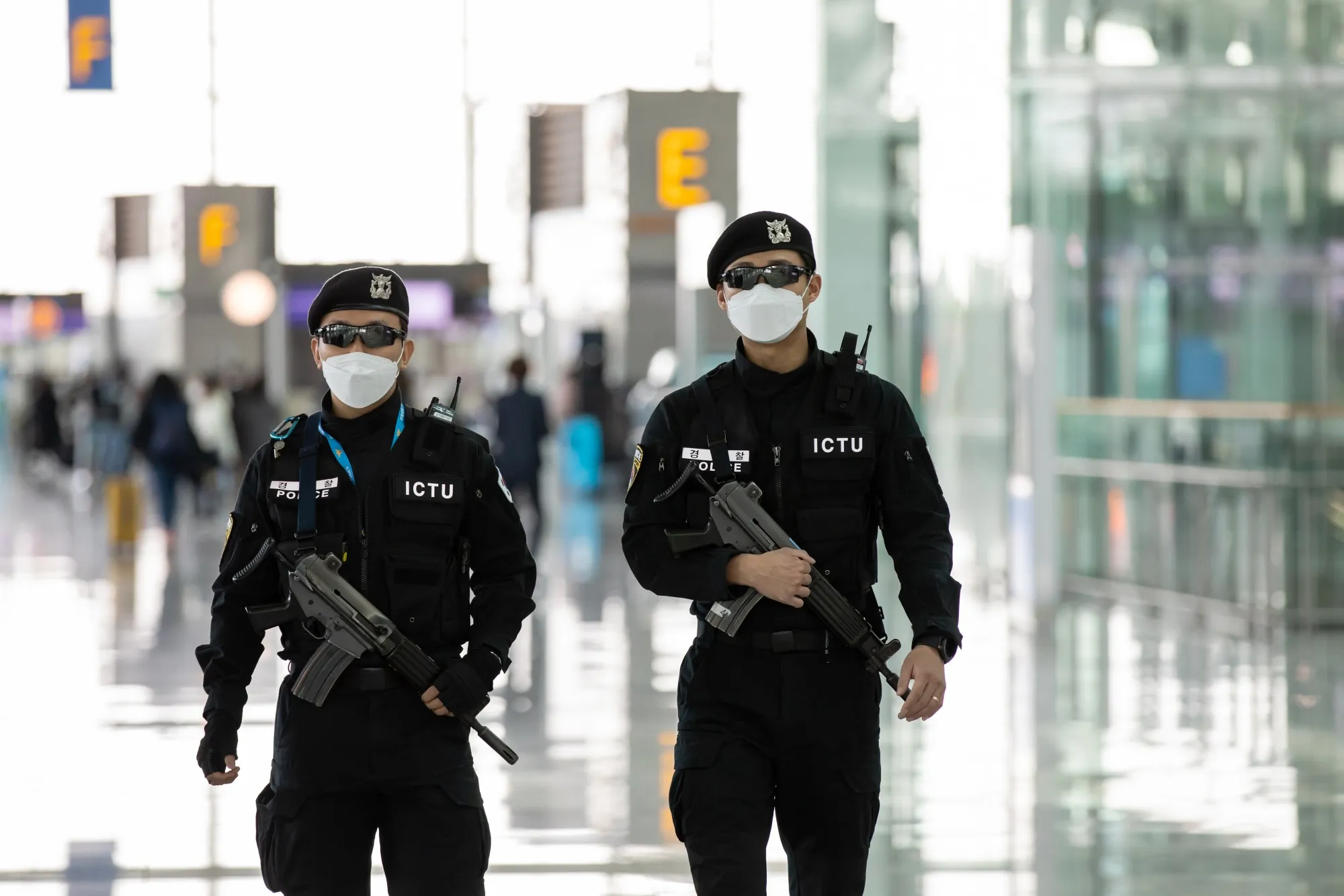 Police officers wearing protective masks patrol Incheon International Airport in Incheon, South Korea, on&nbsp;March 9.&nbsp;