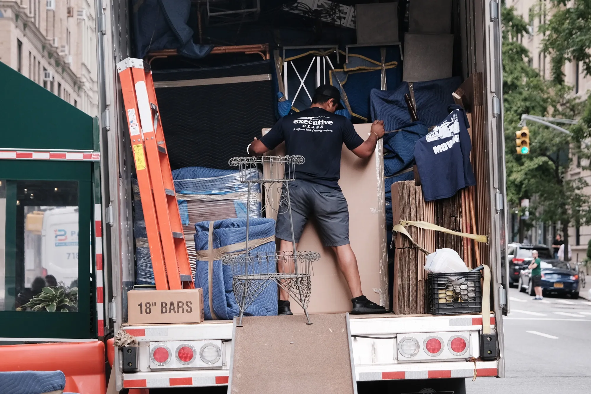 A man moves furniture in a truck in New York City.